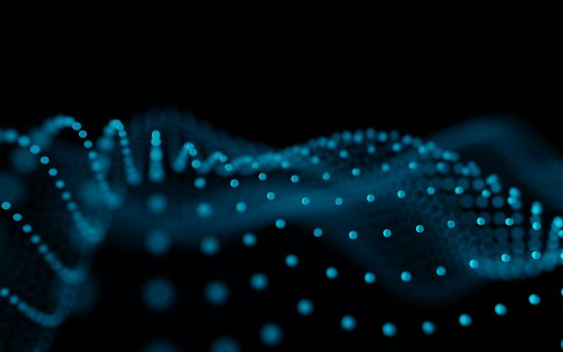 Glowing blue points forming a wave pattern