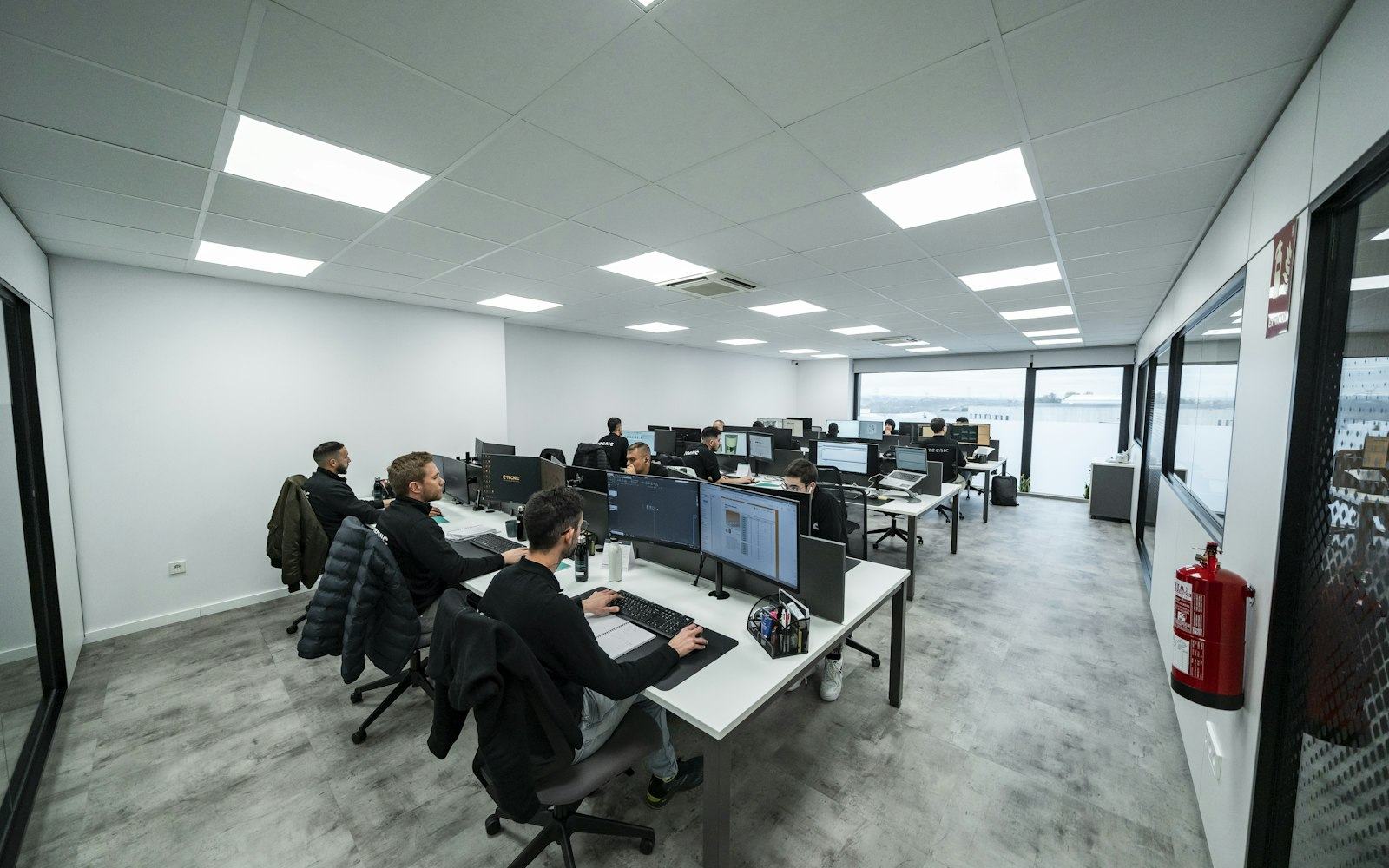 A product team working at screens in a modern office